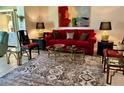Bright living room with a red sofa and tasteful decor at 6812 11Th W Ave # 6812, Bradenton, FL 34209