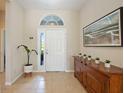 Bright foyer featuring a wooden console table and large artwork at 11410 Griffith Park Ter, Bradenton, FL 34211