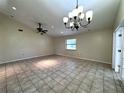 Bright living room with tile floors, ceiling fan, and chandelier at 4601 36Th W Ave, Bradenton, FL 34209