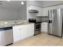 Updated kitchen with stainless steel appliances, granite countertops, and tile flooring at 5278 Sabrina Ter, North Port, FL 34286