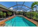 Inviting screened-in pool with a spacious deck area at 225 Brighton Ct, Englewood, FL 34223