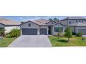 Modern two-story home with two-car garage, gray exterior and paver driveway at 15533 White Linen Dr, Lakewood Ranch, FL 34211