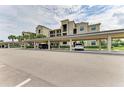 Covered parking area for residents with building view at 18114 Gawthrop Dr # 403, Bradenton, FL 34211