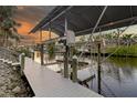 Covered boat lift with dock providing convenient water access at 4611 Shark Dr, Bradenton, FL 34208