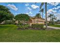 Beautiful single-story home featuring well-manicured lawn and tropical landscaping at 7157 Del Lago Dr, Sarasota, FL 34238