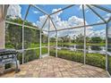 Spacious screened patio with a grill and stunning lake views at 7157 Del Lago Dr, Sarasota, FL 34238