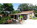Tan house exterior with carport and landscaping at 1820 7Th E Ave, Bradenton, FL 34208