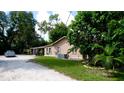 Tan house exterior with carport and landscaping at 1820 7Th E Ave, Bradenton, FL 34208