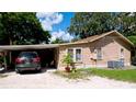 Tan house exterior with carport and landscaping at 1820 7Th E Ave, Bradenton, FL 34208