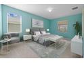 Bright bedroom with a king-size bed and sitting area at 1717 Bonita Bluff Ct, Ruskin, FL 33570