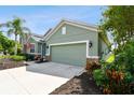 Attached garage with a light-green door and a stone accent at 5056 Lakehurst Ct, Palmetto, FL 34221