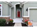 Inviting front entry with a red door and stone accents at 5056 Lakehurst Ct, Palmetto, FL 34221