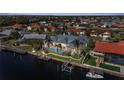 An aerial view of a home with a pool and dock on a canal leading to the bay at 239 Fry Se Ter, Port Charlotte, FL 33952