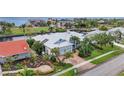 A beautiful two-story waterfront home features a metal roof, lush landscaping and brick paved driveway at 239 Fry Se Ter, Port Charlotte, FL 33952