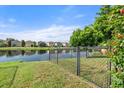 Backyard with a fenced area and lake view at 7022 Chatum Light Run, Bradenton, FL 34212