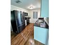 Modern kitchen with black appliances and granite countertops at 20437 Midway Blvd, Port Charlotte, FL 33952