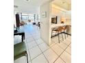 Open kitchen with breakfast bar and view into the living area at 1065 Gulf Of Mexico Dr # 302, Longboat Key, FL 34228
