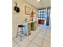 Bright entryway with vintage console table at 1065 Gulf Of Mexico Dr # 302, Longboat Key, FL 34228