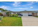 Single story home with a large yard, driveway and mature landscaping at 3917 Cochise Ter, Sarasota, FL 34233