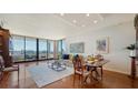 Bright living room with hardwood floors, city view, and balcony access at 1255 N Gulfstream Ave # 1003, Sarasota, FL 34236
