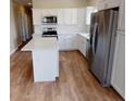 Modern kitchen with island and stainless steel appliances at 710 N Thomas St, Plant City, FL 33563