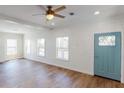 Living room with light wood floors and blue door at 710 N Thomas St, Plant City, FL 33563