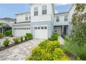 Two-story townhome with two-car garage and landscaped front yard at 4119 Via Sienna Cir, Sarasota, FL 34243