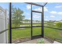 Relaxing screened porch with pond view in a community setting at 4119 Via Sienna Cir, Sarasota, FL 34243