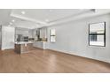 Open-concept kitchen and dining area featuring an island, stainless appliances, and hardwood floors, ideal for modern living at 18812 Dayspring Pl, Venice, FL 34293
