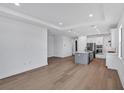 Open-concept kitchen with island, stainless steel appliances, and hardwood floors at 18824 Dayspring Pl, Venice, FL 34293