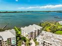 Aerial view of the condo complex with pristine bay waters in the background at 236 Hidden Bay Dr # 301, Osprey, FL 34229