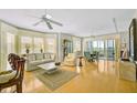 Bright living room boasts hardwood floors, neutral paint, and large windows with water views and access to a balcony at 236 Hidden Bay Dr # 301, Osprey, FL 34229