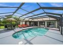 Relaxing pool area with a covered patio and lounge chairs at 10194 Thames Ave, Englewood, FL 34224
