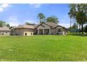 Charming house with a spacious front yard at 11358 Lomita Wren Rd, Weeki Wachee, FL 34614