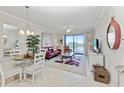 Living room with lake views, comfortable seating, and dining area at 6519 Grand Estuary Trl # 205, Bradenton, FL 34212