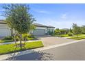 Beautiful home with a two-car garage, paver driveway, and lovely landscaping in a quiet neighborhood at 14480 Eagle Branch Dr, Nokomis, FL 34275