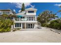 Charming beach house featuring a multi-level deck, elegant railing, and beachside charm at 3007 Avenue F # 1, Bradenton Beach, FL 34217