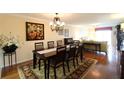 View of the dining room with seating for eight and hardwood floors at 3807 Lake Bayshore Dr # H-416, Bradenton, FL 34205