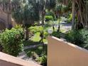 Mature tropical landscape surrounding the condo with brick pavers and manicured bushes and palm trees at 3810 75Th W St # 116, Bradenton, FL 34209