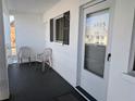 Inviting condo entrance featuring a tiled porch with two chairs and unit number displayed above the door at 5925 Todd St # D-21, Bradenton, FL 34207