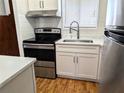 Modern kitchen with stainless steel appliances, white cabinets, laminate countertops, and stainless steel faucet at 5925 Todd St # D-21, Bradenton, FL 34207