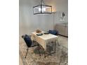 Bright dining area featuring a table set for two, stylish lighting, and a decorative area rug at 5956 Clubside Dr # 7651, Sarasota, FL 34243