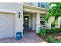Front entry with teal door, paver walkway, and landscaping at 3360 Chestertown Loop, Bradenton, FL 34211