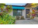 Private front patio with lush tropical landscaping at 5956 Clubside Dr # 7651, Sarasota, FL 34243