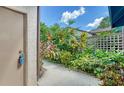 Landscaped side yard with walkway and privacy fence at 5956 Clubside Dr, Sarasota, FL 34243