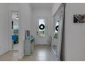 Bright entryway with mirror, console table, and view to bedroom at 14480 Eagle Branch Dr, Nokomis, FL 34275