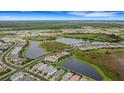 Aerial view showing home's location in a community with ponds at 14480 Eagle Branch Dr, Nokomis, FL 34275