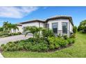 Single-story home with landscaped yard and two-car garage at 14480 Eagle Branch Dr, Nokomis, FL 34275