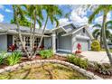 Beautiful single-story home with a two-car garage, mature palm trees, and lovely landscaping at 5306 19Th W Ave, Bradenton, FL 34209