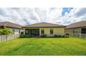 Large backyard with screened patio and grassy area at 220 Capriana Ct, Nokomis, FL 34275